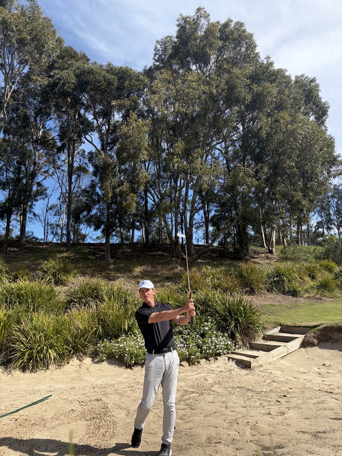Matthew Davis facing the camera after a bunker shot in Heatherton